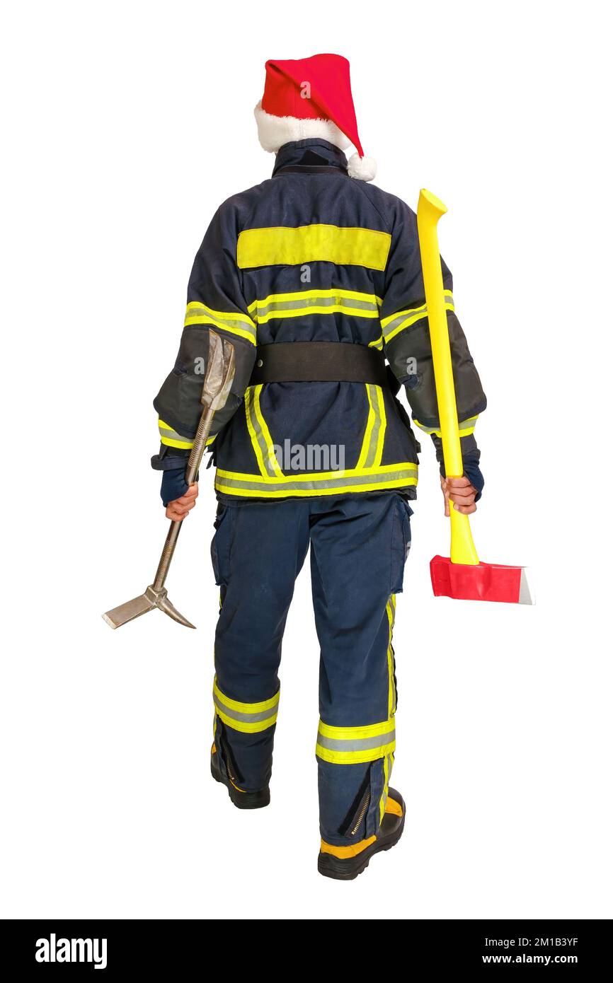 Fireman in red santa hat holds axe and crowbar in hands isolated Stock Photo