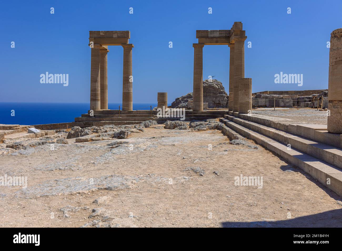 Panoramic view of ruins of ancient city of Lindos on colorful island of ...