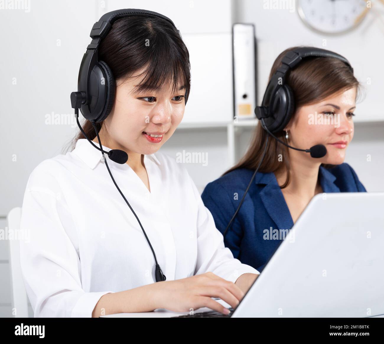 Operators working with computers in an office Stock Photo - Alamy