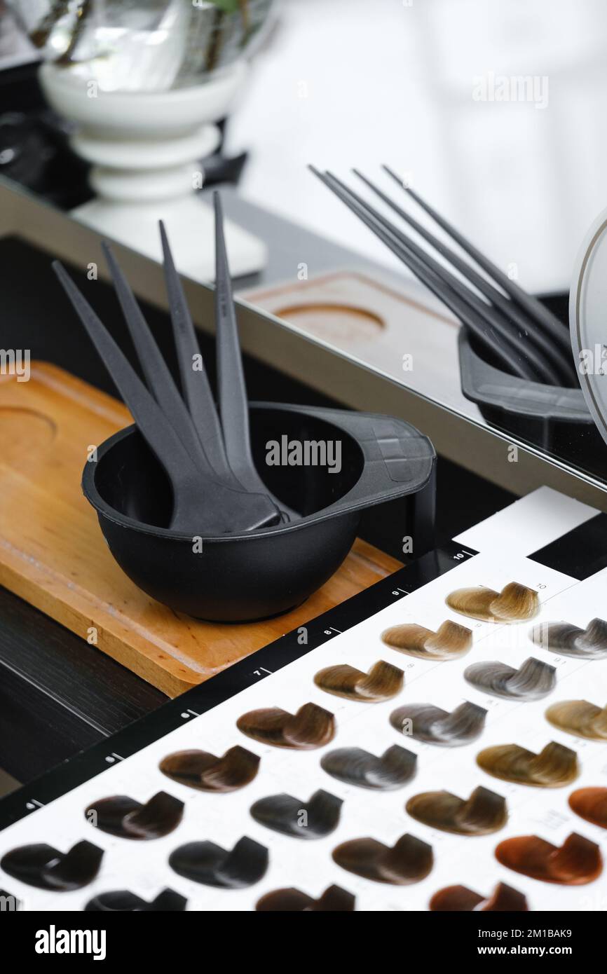 Hair color samples, hair palette and working tools in hairdressing salon. Hairdresser Working place with catalog of paint colors. Close-up  Stock Photo