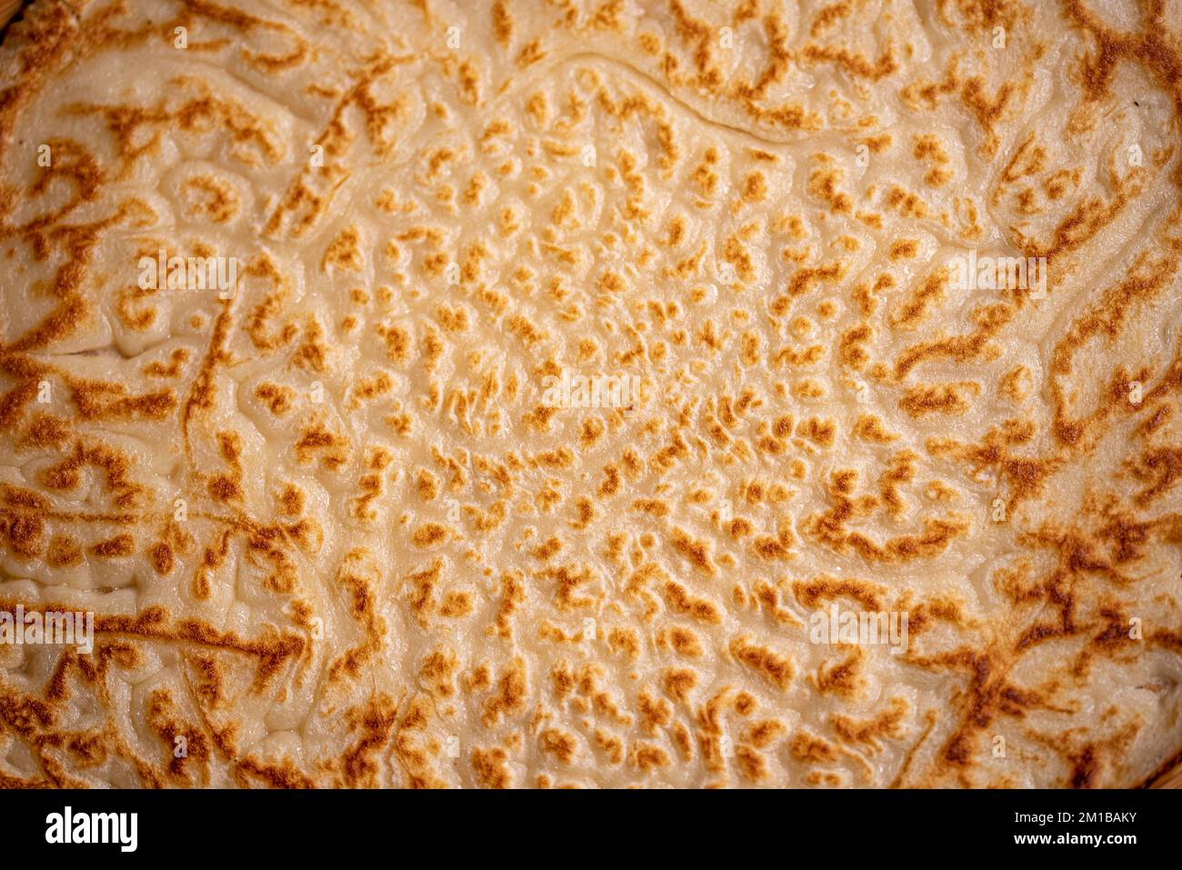 Pancake. Background. Hot, freshly baked pancake. Macro photography of pancake. Close-up of pancake. Macro photo of food. Beautiful food cover. Stock Photo