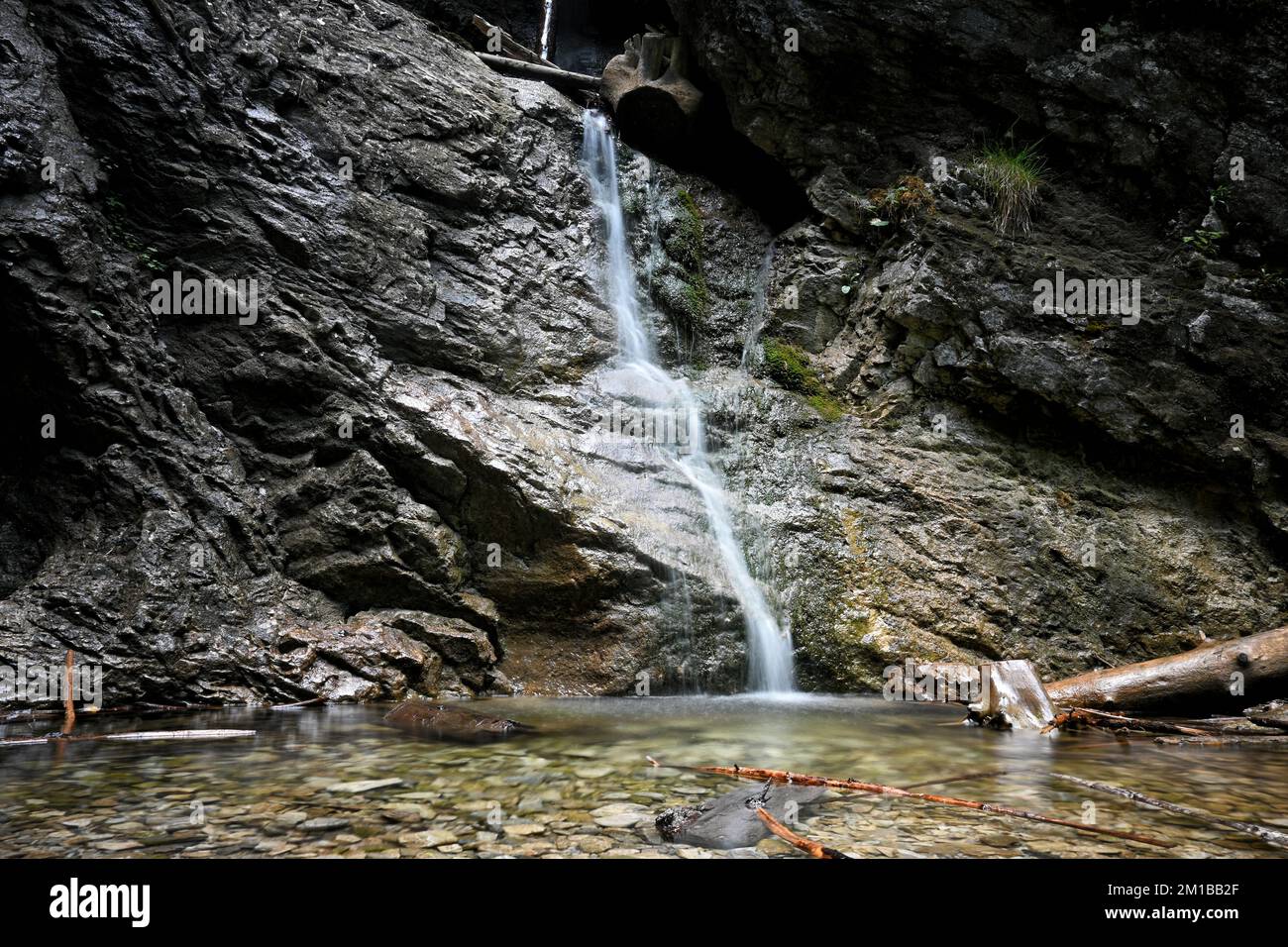 A beautiful shot of a waterfall coming out from a cliff Stock Photo - Alamy