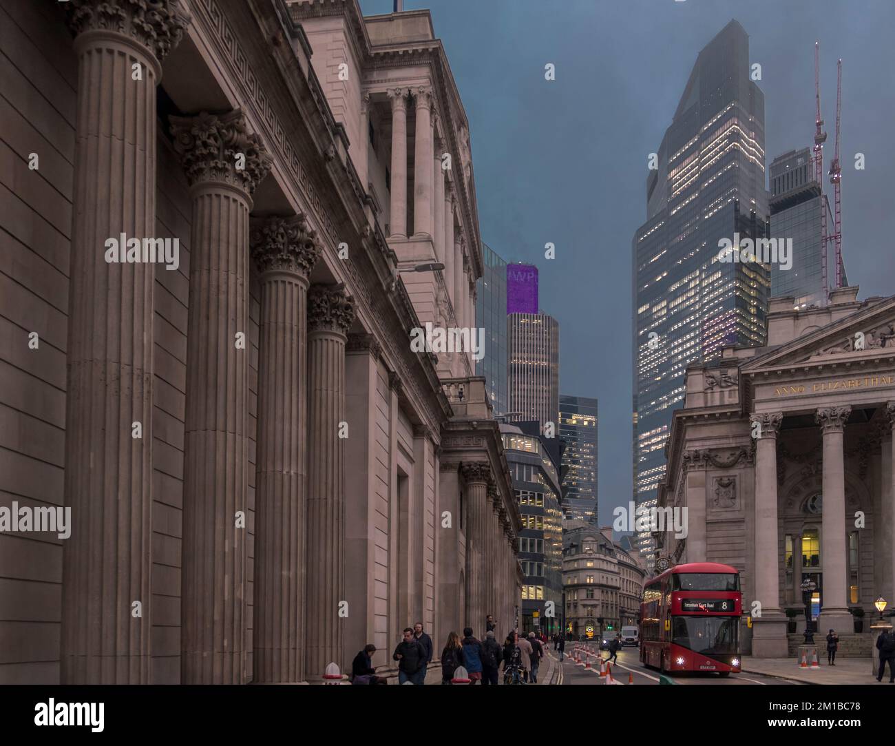On a murky winter's evening Threadneedle Street looking east towards Bishopsgate at dusk in The City of London. Bank of England (on left). Stock Photo