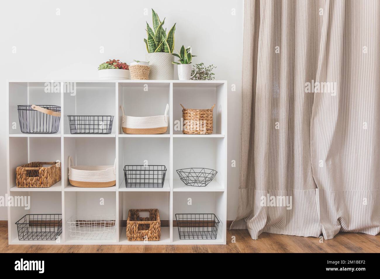 White stylish shelf in scandi style. Storage baskets. Japanese method  organizer boxes set. Closet organizing concept Stock Photo - Alamy