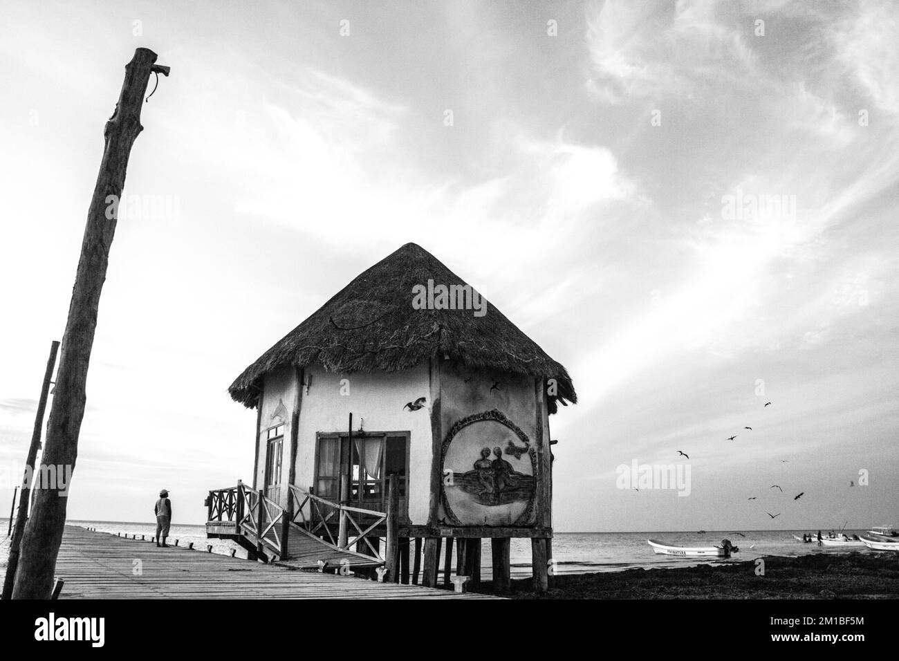 A grayscale view of a hut next to the dock in Holbox island, Mexico Stock Photo