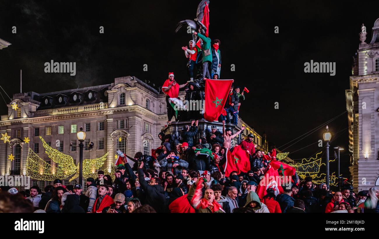 Morocco, arab, and african fans celebrate in London's Piccadilly after Morocco's continued success in the Qatar World Cup. Stock Photo