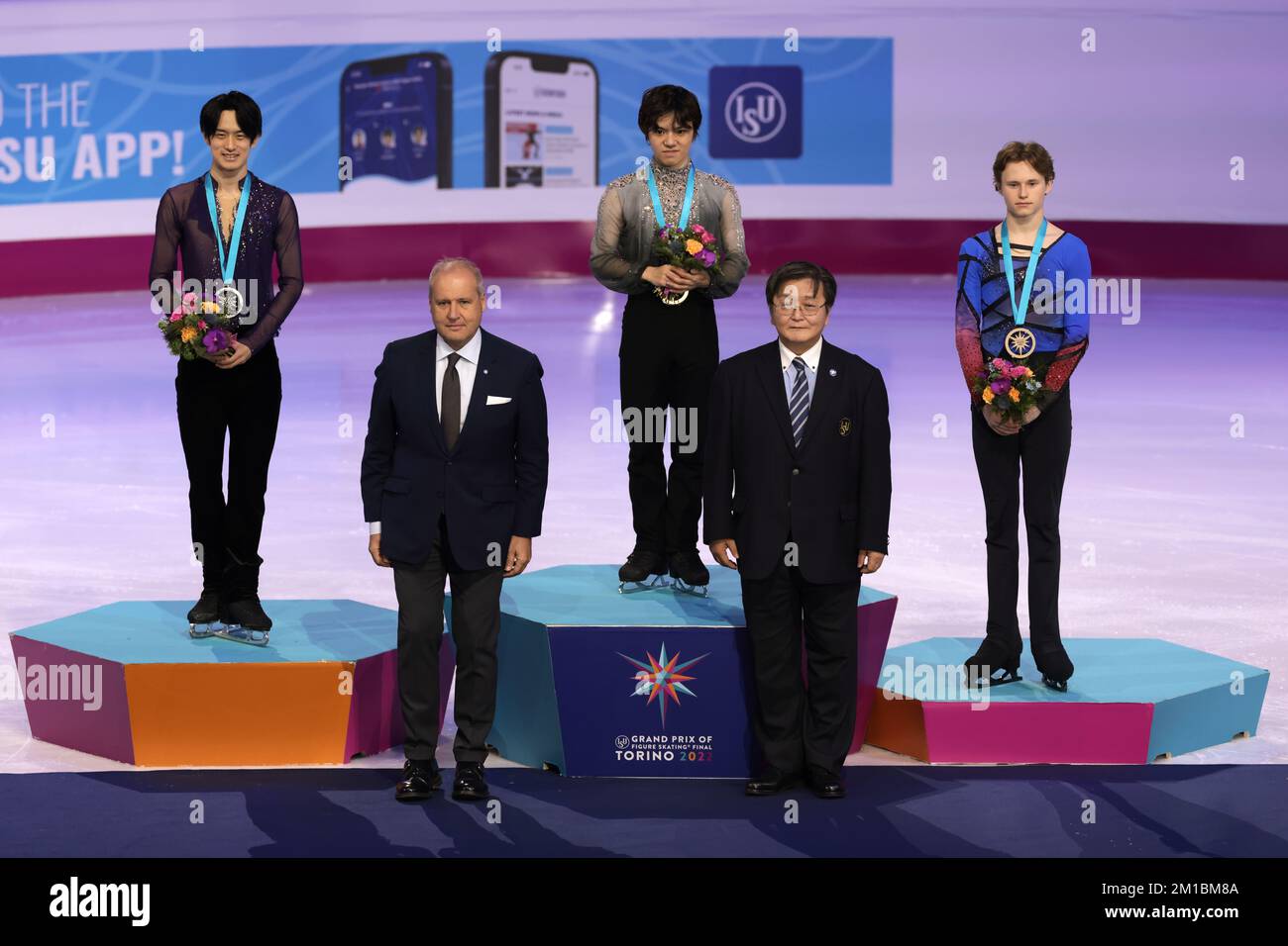 Turin, Italy. 10th Dec, 2022. Men's Medalists ( L to R ); Sota Yamamoto of Japan ( Silver ), Shoma Uno of Japan ( Gold ) and Ilia Malinin of USA ( Bronze ) pictured on the Winners' Podium along with ( lower left ) Andrea Gios President of the Italian Ice Sports Federation ( FISG ) and ( lower right ) Mr. Tatsuro Matsumura of ISU Development Commission Palavela, Turin. Picture date: 10th December 2022. Picture credit should read: Jonathan Moscrop/Sportimage Credit: Sportimage/Alamy Live News Stock Photo