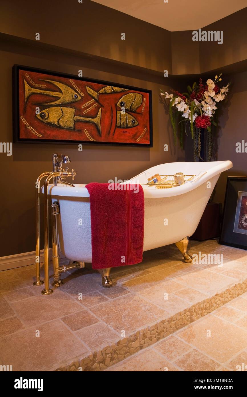 Old fashioned freestanding soaking bathtub on ceramic base in basement