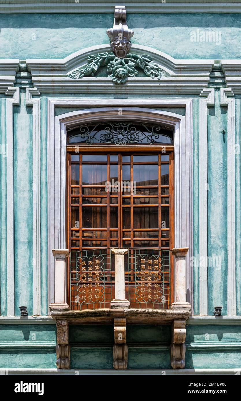 Colonial style balcony with window and turquoise facade in Cuenca, Ecuador. Stock Photo