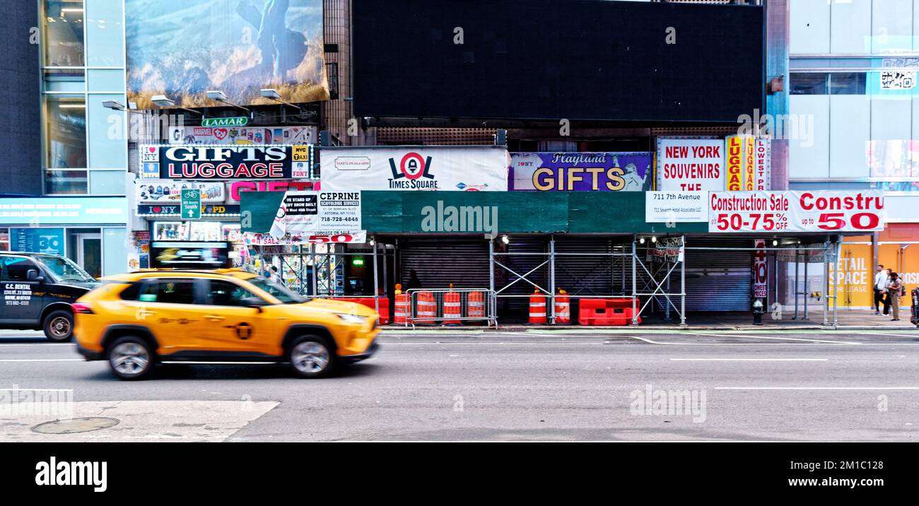 Yellow Cab Speeding Past New York Stores Stock Photo
