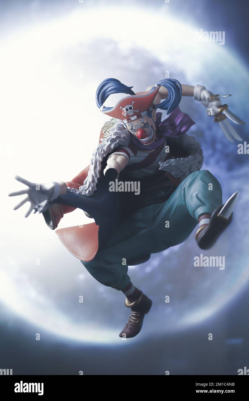 An action figurine of Buggy the Star Clown from One Piece with a gorgeous fantasy moon background Stock Photo