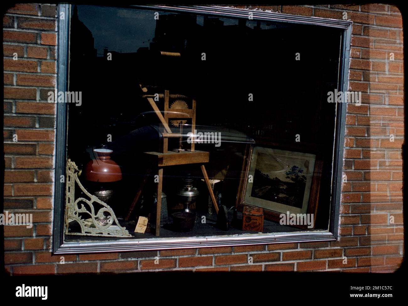 Window Display For Tools Window in brick wall displaying tools, framed picture, and other ...