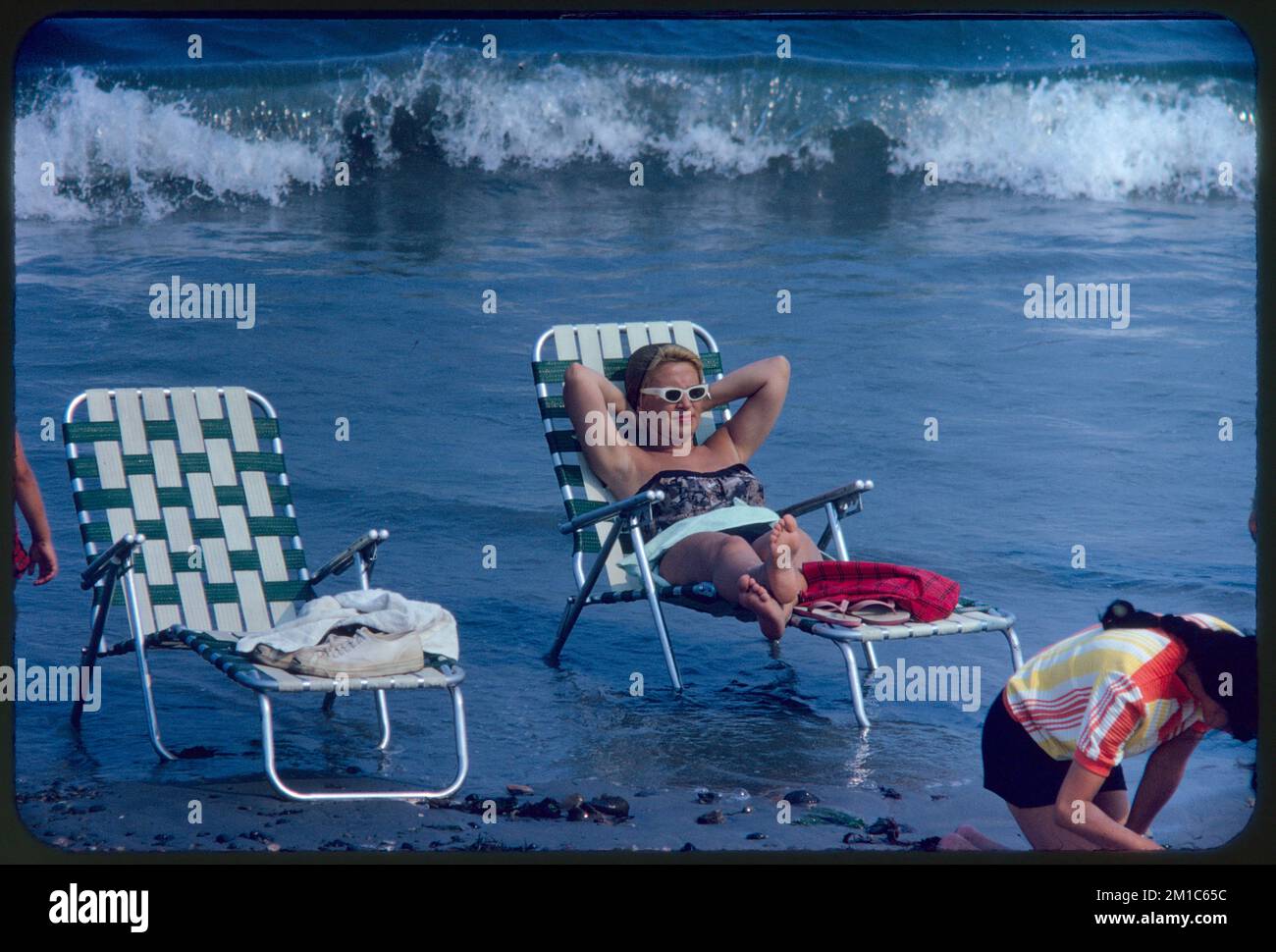 Woman lounging on beach chair, Revere Beach , Beaches, Bathing suits