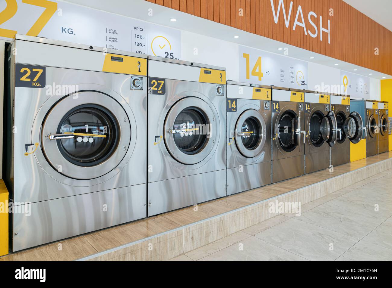 A row of qualified coinoperated washing machines in a public store