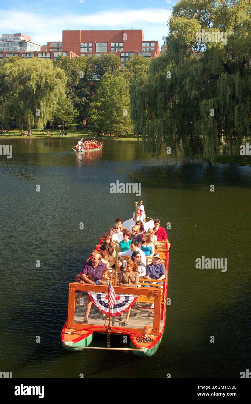 A group of people take a ride on the Historic Swan Boats in Boston's Publik Garden Stock Photo