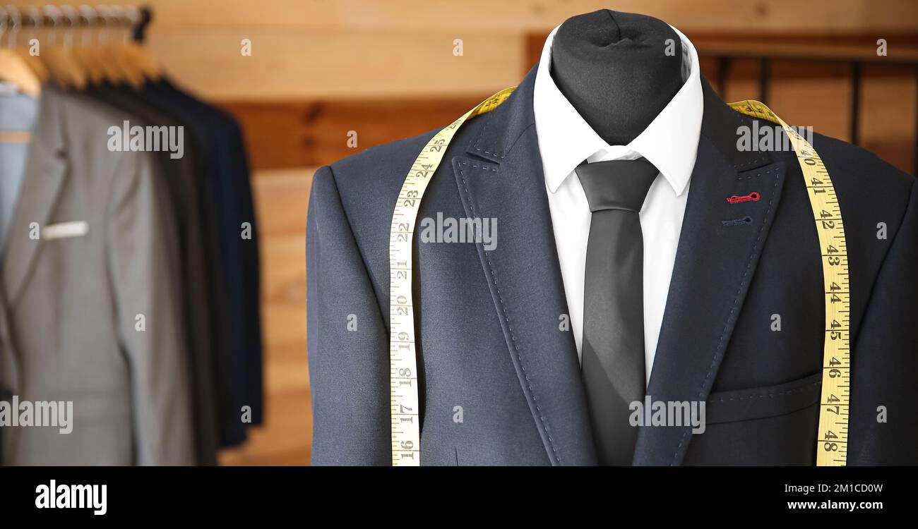 Mannequin with new male suit and measuring tape in workshop Stock Photo ...