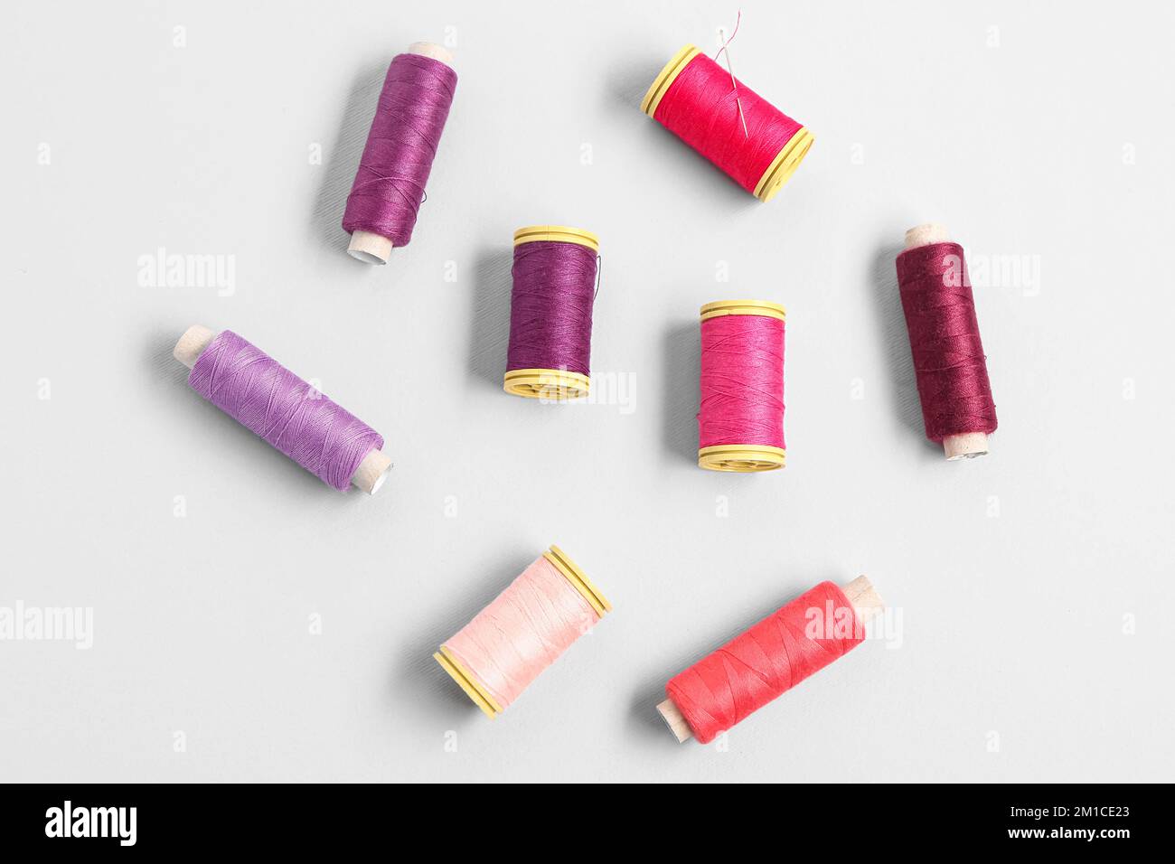 Set of colorful thread spools on light background Stock Photo - Alamy