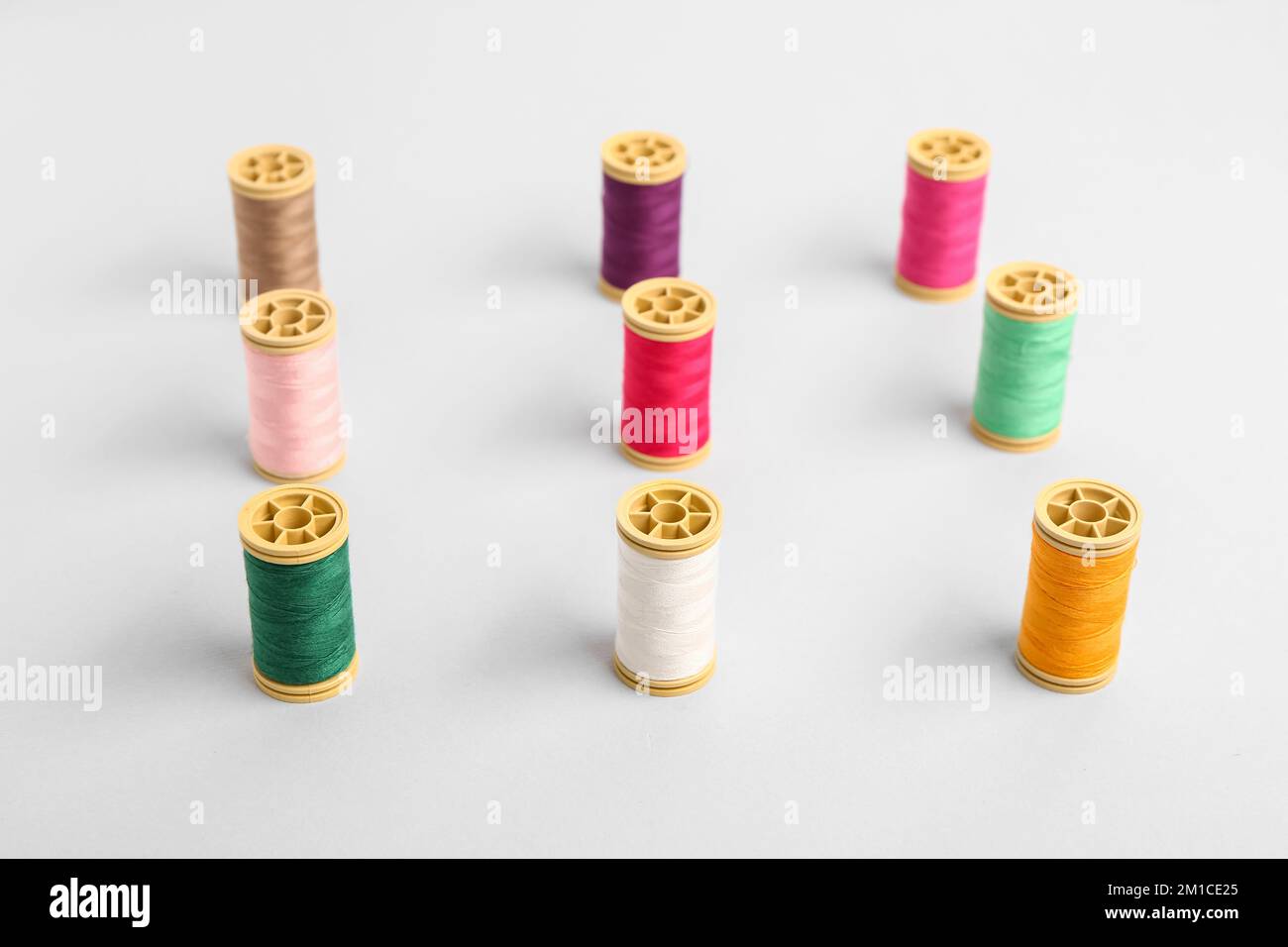Many different thread spools on light background Stock Photo
