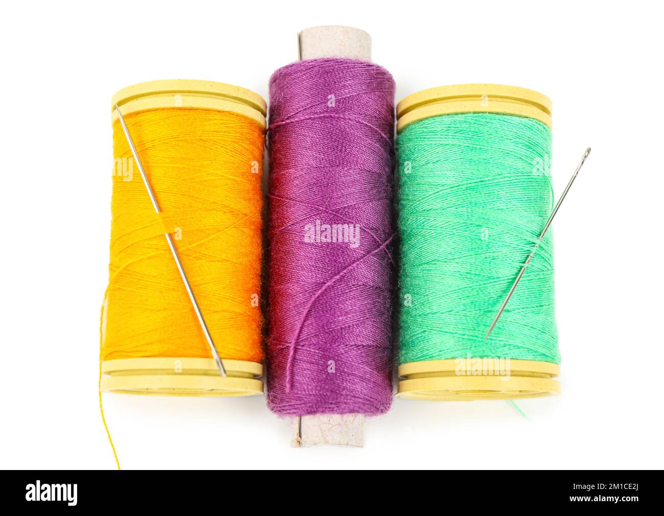 Colorful thread spools with needles on white background Stock Photo - Alamy
