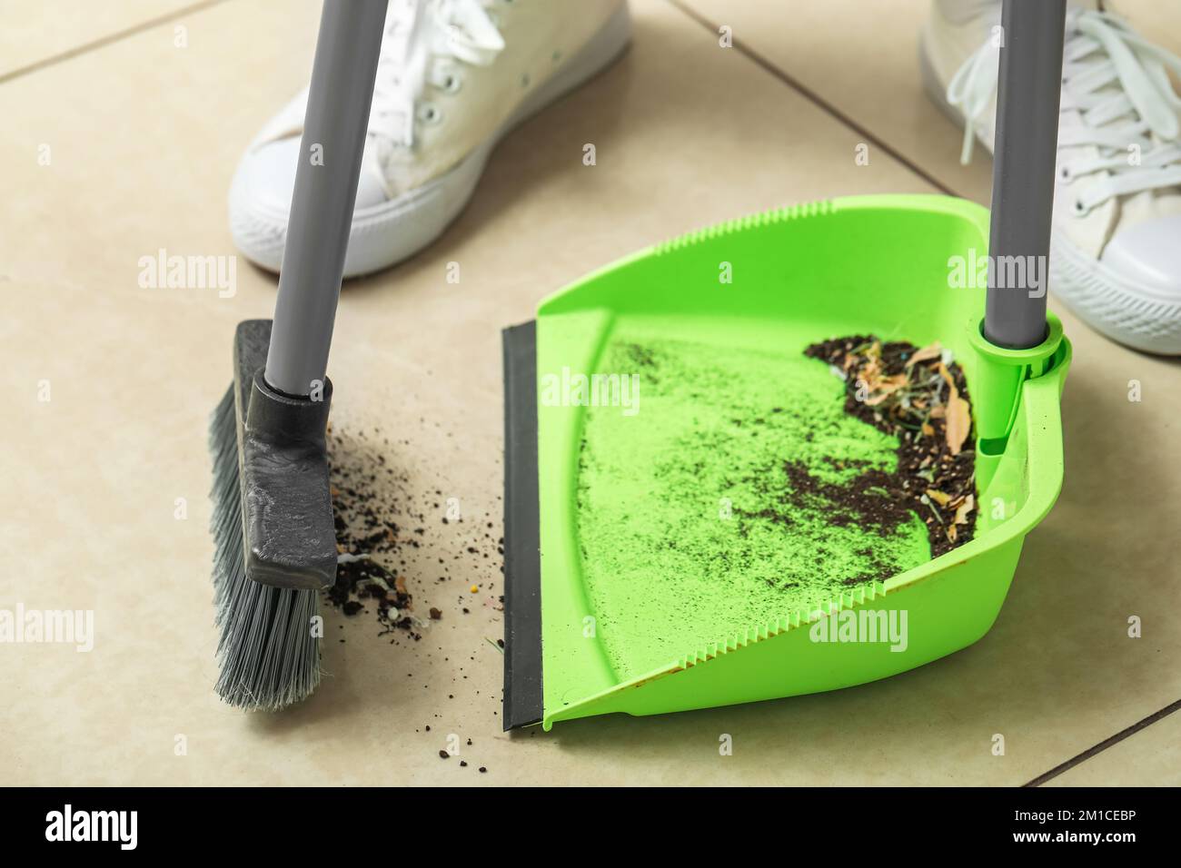 Woman sweeping tile floor hi-res stock photography and images - Alamy