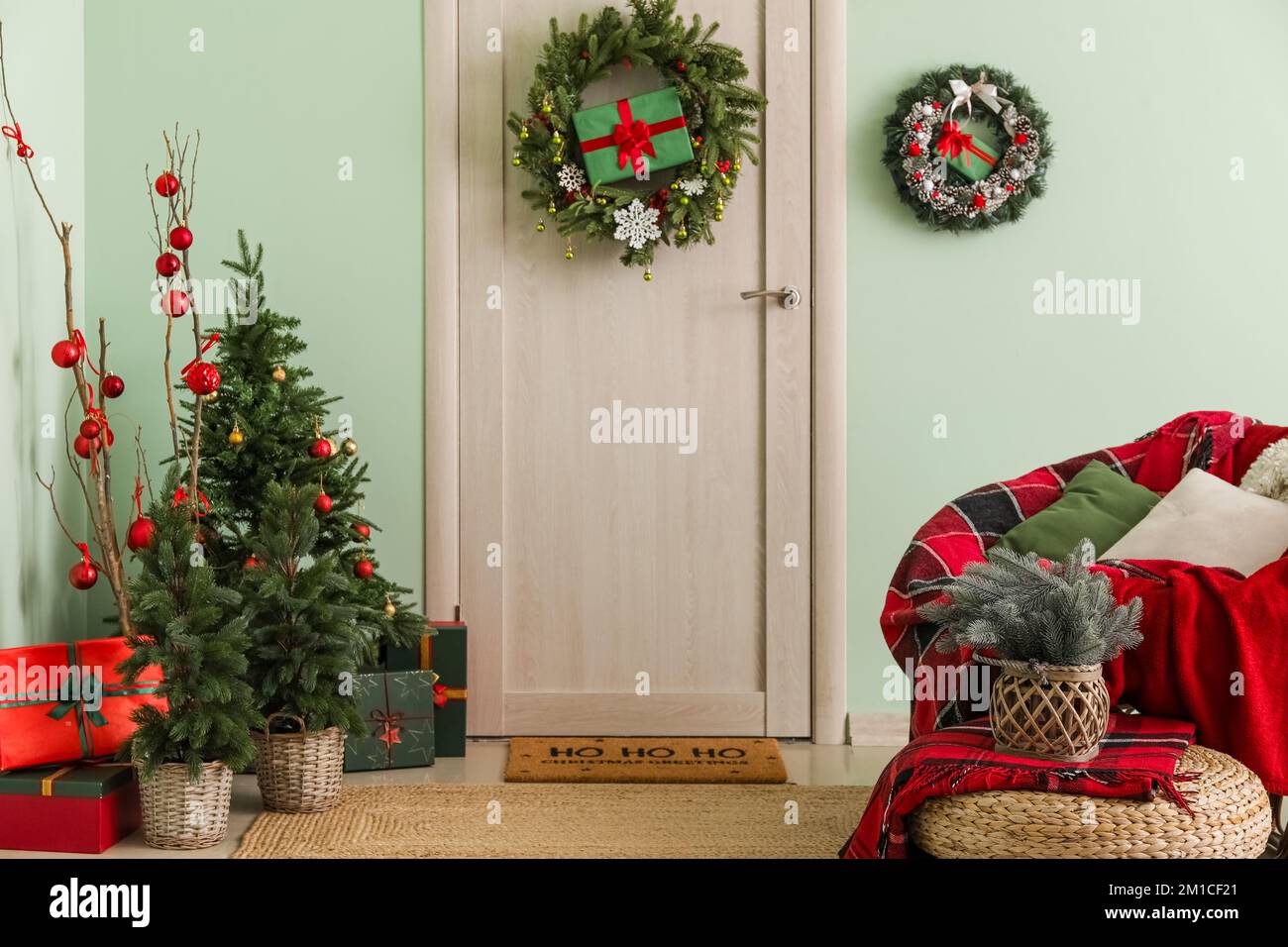 Interior of hall with wooden door, Christmas decor and armchair Stock ...