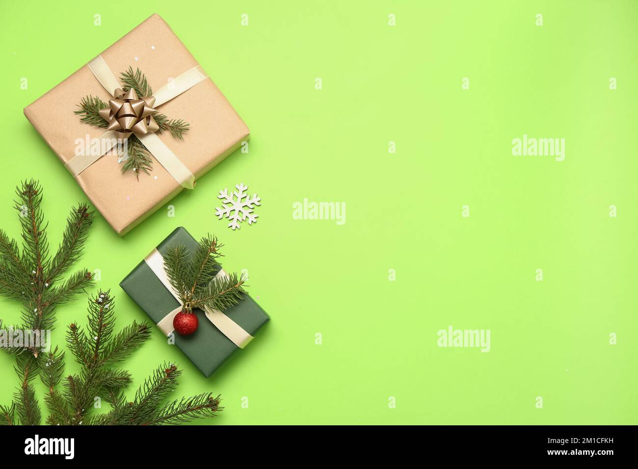 Christmas gift boxes with fir branches on green background Stock Photo ...