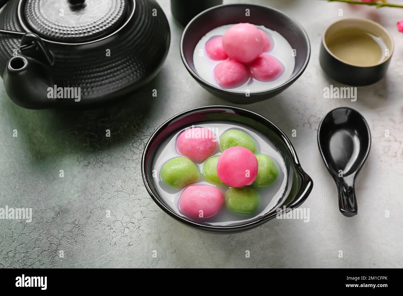 Bowls of tangyuan, cup and teapot on grunge background. Dongzhi ...