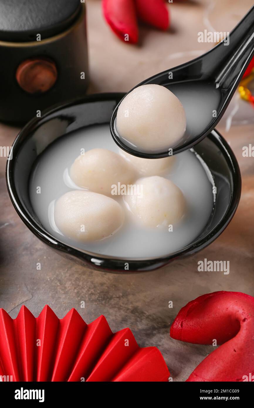 Spoon and bowl of tangyuan on grunge background, closeup. Dongzhi ...
