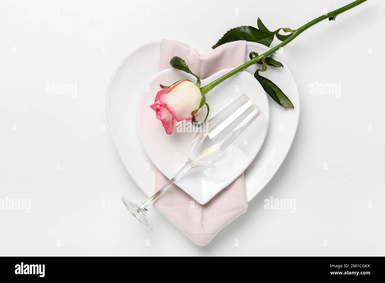 Table setting for Valentine's Day with rose on white background Stock ...