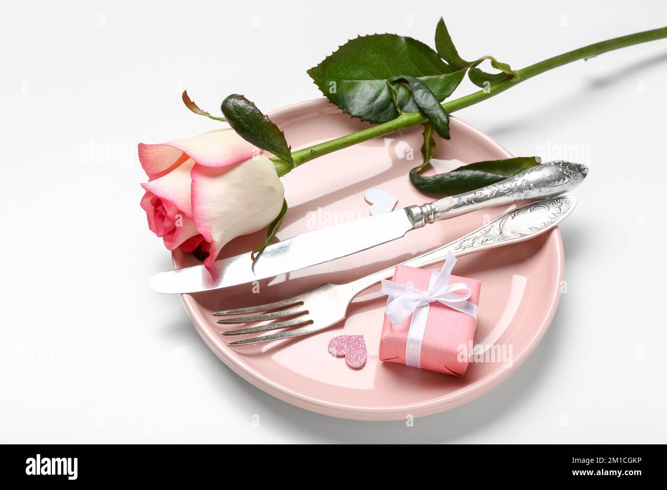Table setting for Valentine's Day with rose on white background Stock ...