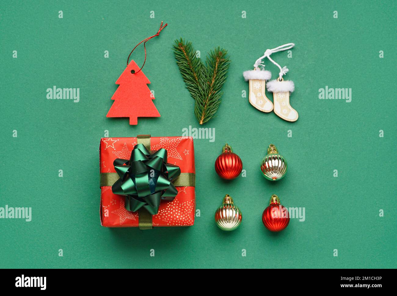 Gift box with Christmas toys and fir branches on green background Stock ...