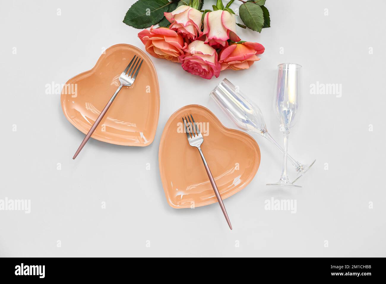 Table setting for Valentine's Day with roses on white background Stock ...