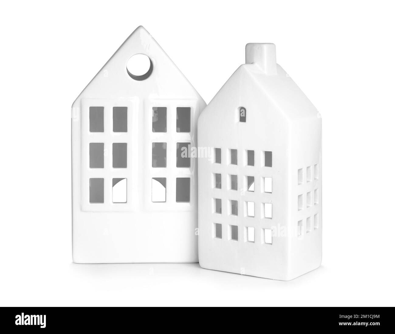 Candle holders in shape of houses on white background Stock Photo - Alamy