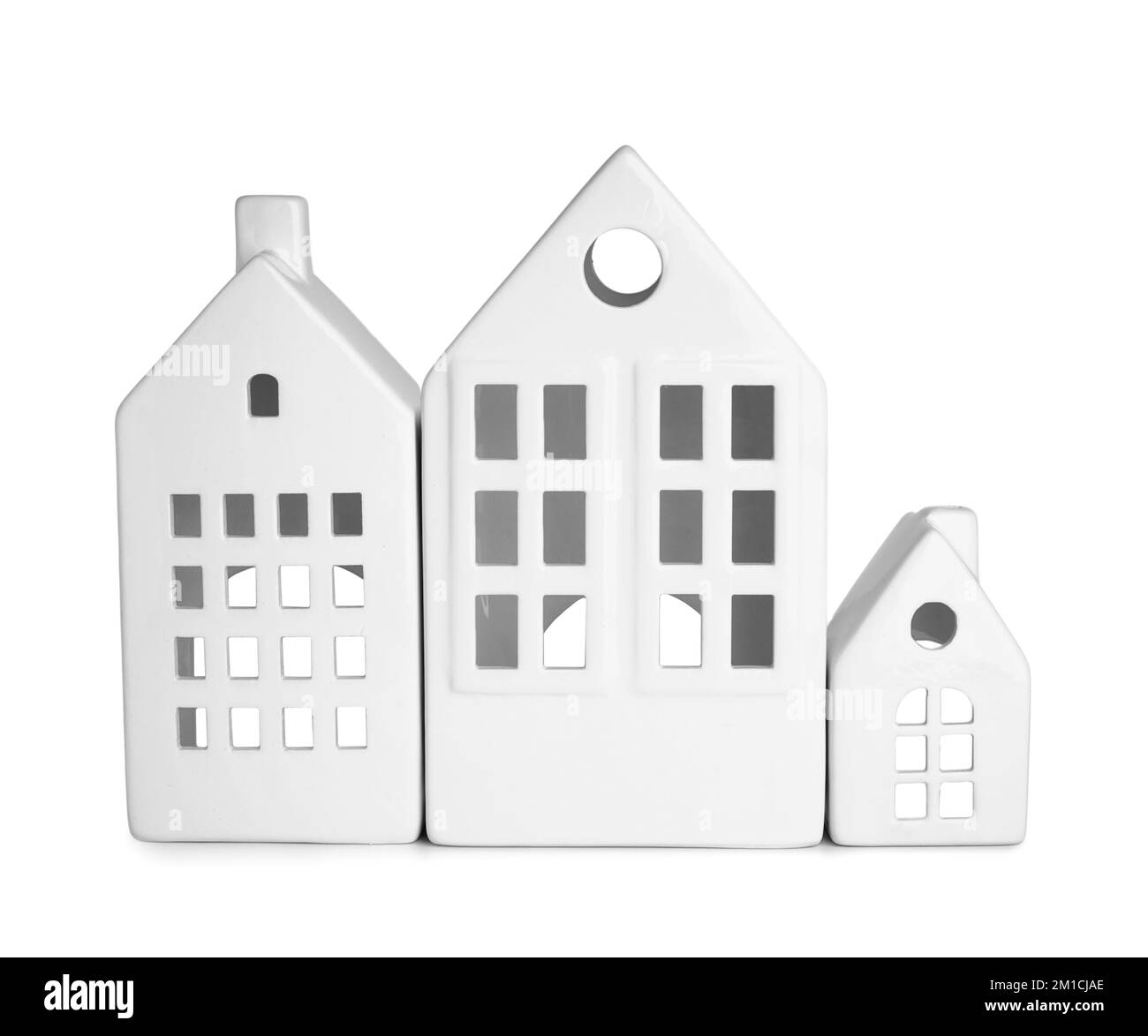 Candle holders in shape of houses on white background Stock Photo - Alamy