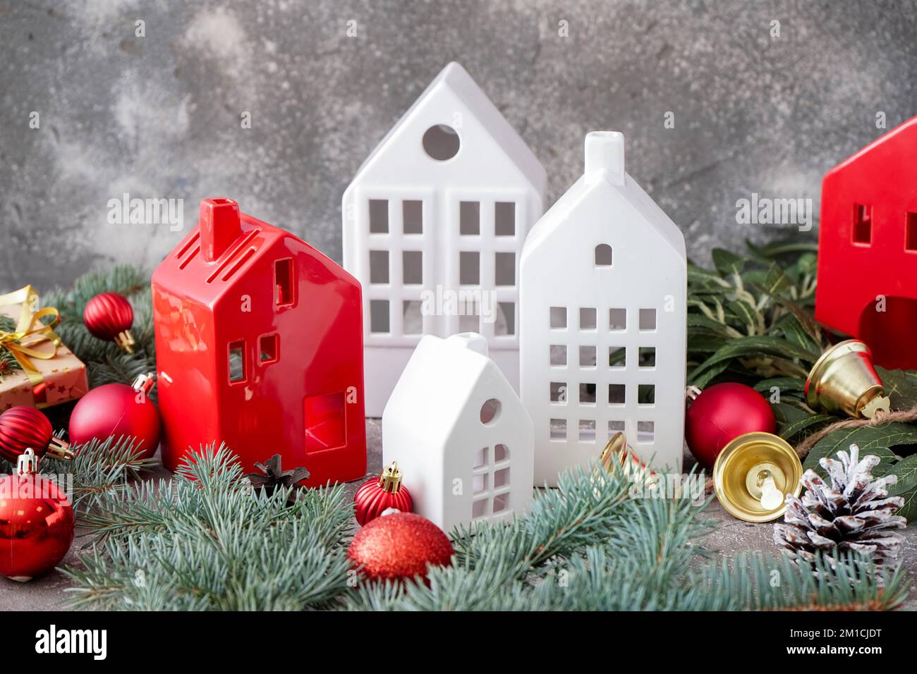 House shaped candle holders with Christmas balls and fir branches on