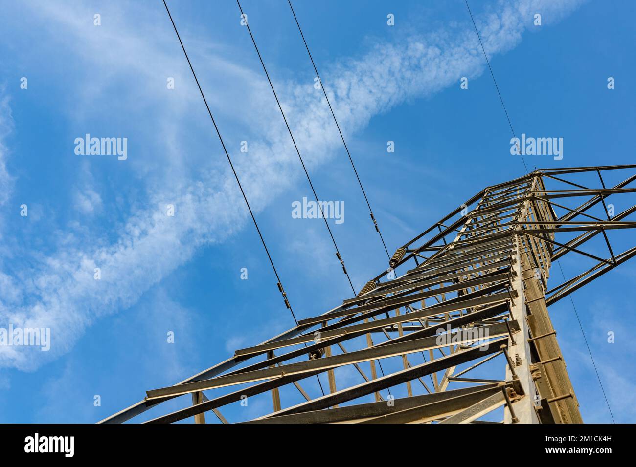Transmission power lines from below over a clear blue sky Stock Photo ...