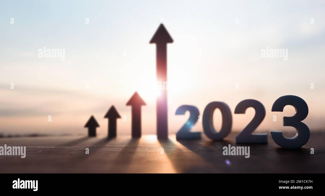 High rising arrow and bright rising sun 2023 new year sunrise and stock finance economy industry growth investment target concept Stock Photo