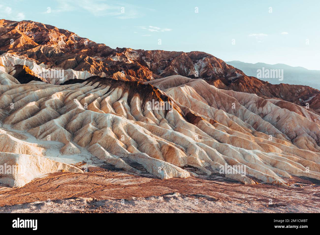 The sun rises over Zabriskie Point in Death Valley  Stock Photo
