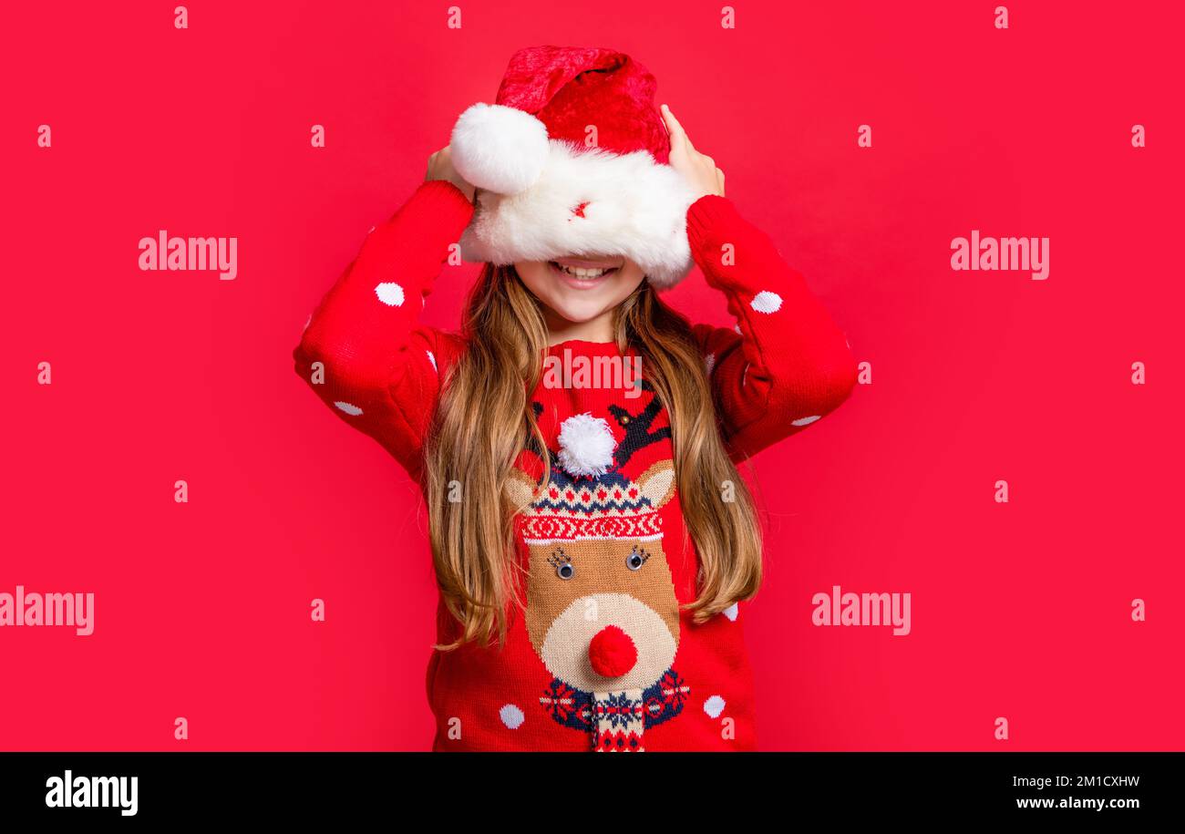teen girl wearing sweater and santa hat at christmas holiday. merry