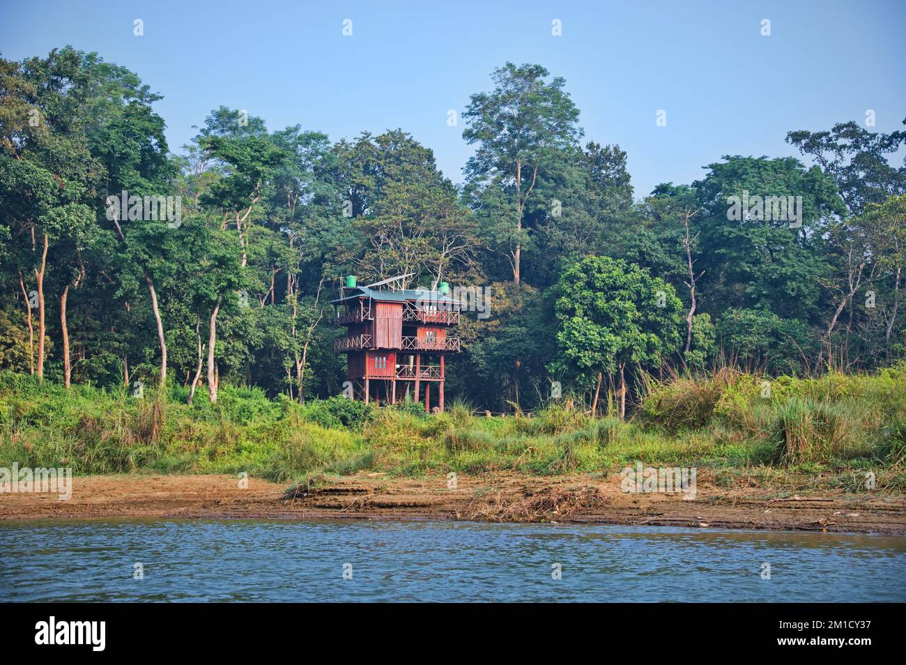 Wooden cottage on the lake shore in National Park in Nepal Stock Photo