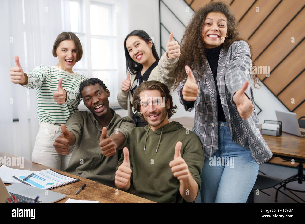 happy business team showing thumbs up. close-up Stock Photo - Alamy