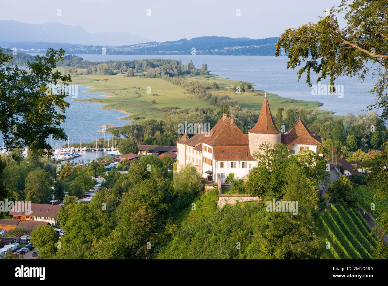 The Erlach Castle is located on a hill and surrounded by wine yards, overlooking the Lake Biel and the St. Peter peninsula Stock Photo