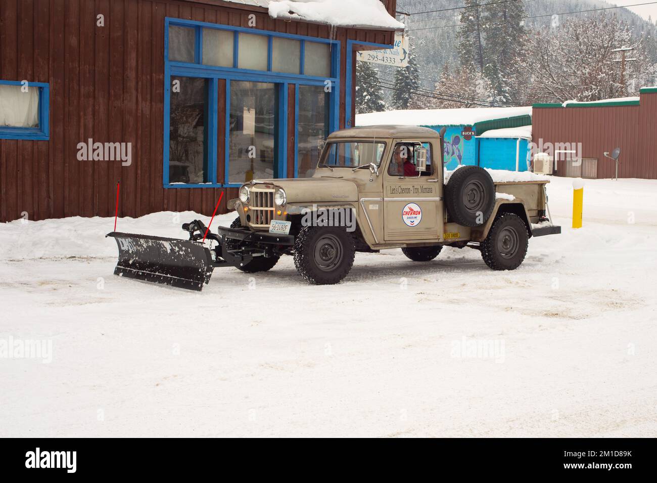 A 1962 Kaiser Willys Jeep pickup truck plowing snow in Troy, Montana. Stock Photo