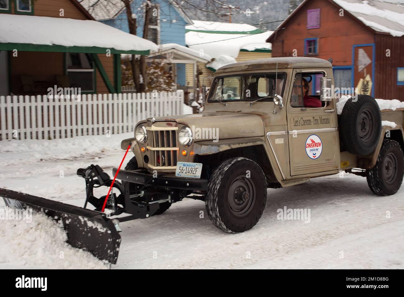 A 1962 Kaiser Willys Jeep pickup truck plowing snow in Troy, Montana. Stock Photo