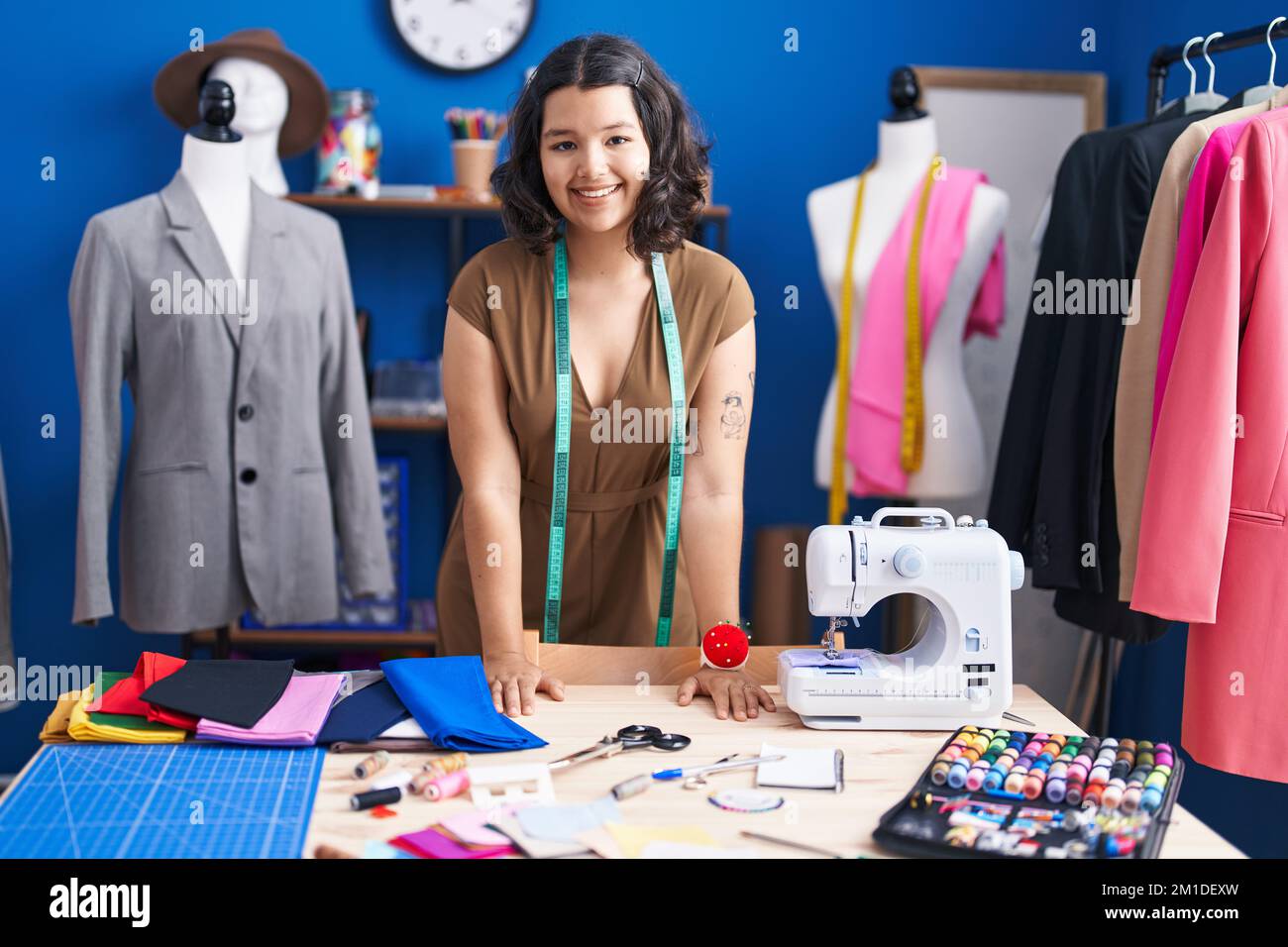 Young woman tailor smiling confident standing at sewing studio Stock ...