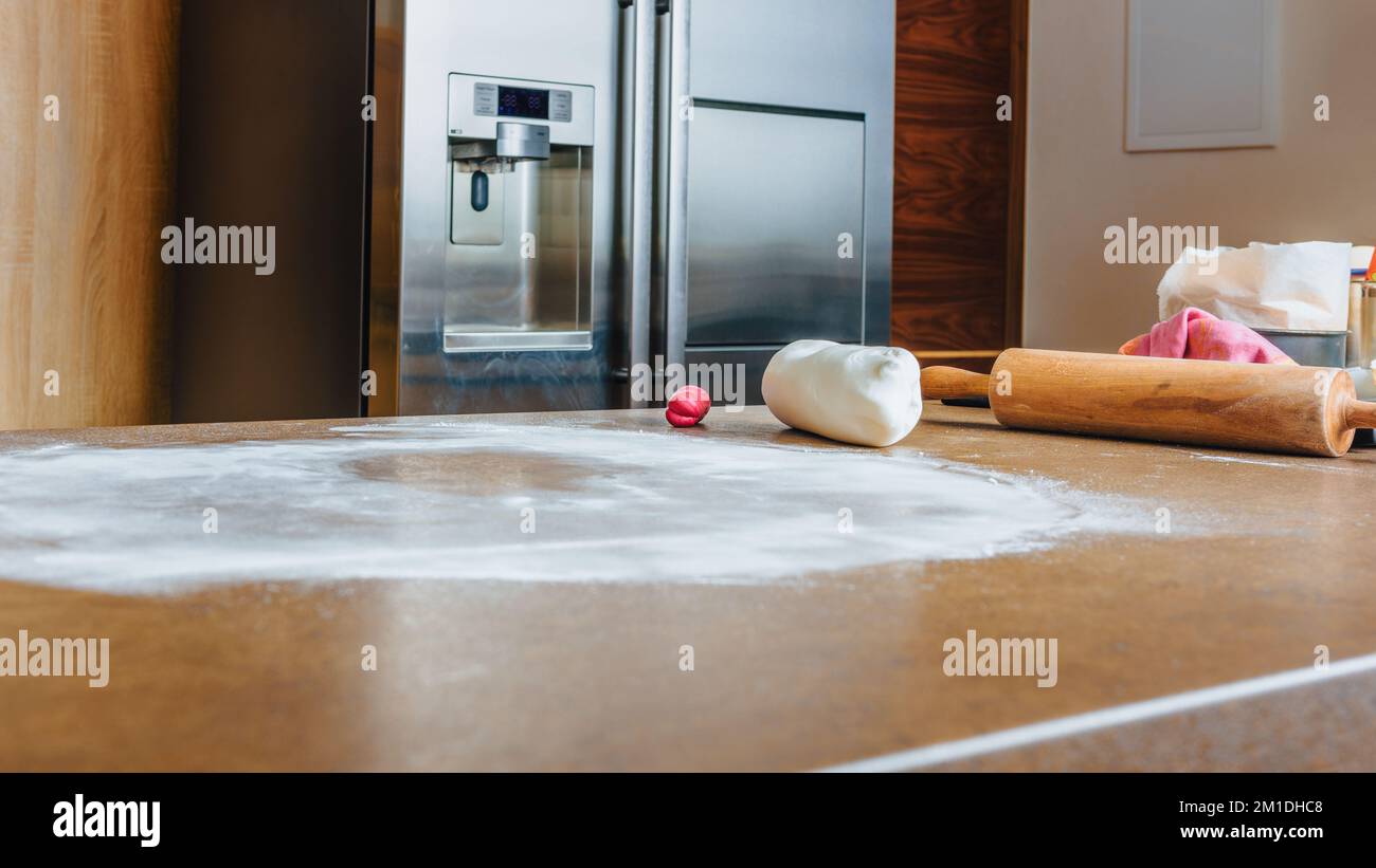 Rolling pin and white sugar paste on kitchen counter. DIY, sequence, step by step. Stock Photo