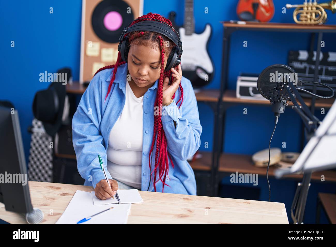 African american woman artist composing song at music studio Stock ...