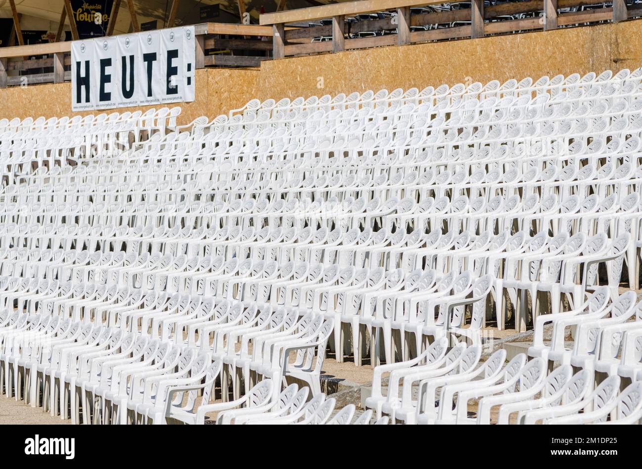 White plastic chairs arranged in rows in an open air concert area Stock ...