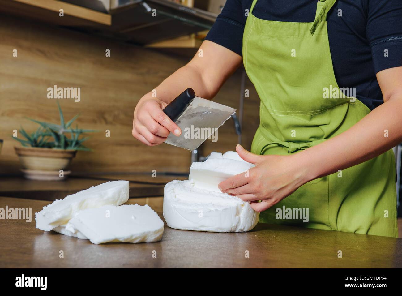 Unrecognisable woman preparing white fondant for cake decorating, hands detail. DIY, sequence, step by step, part of series. Stock Photo