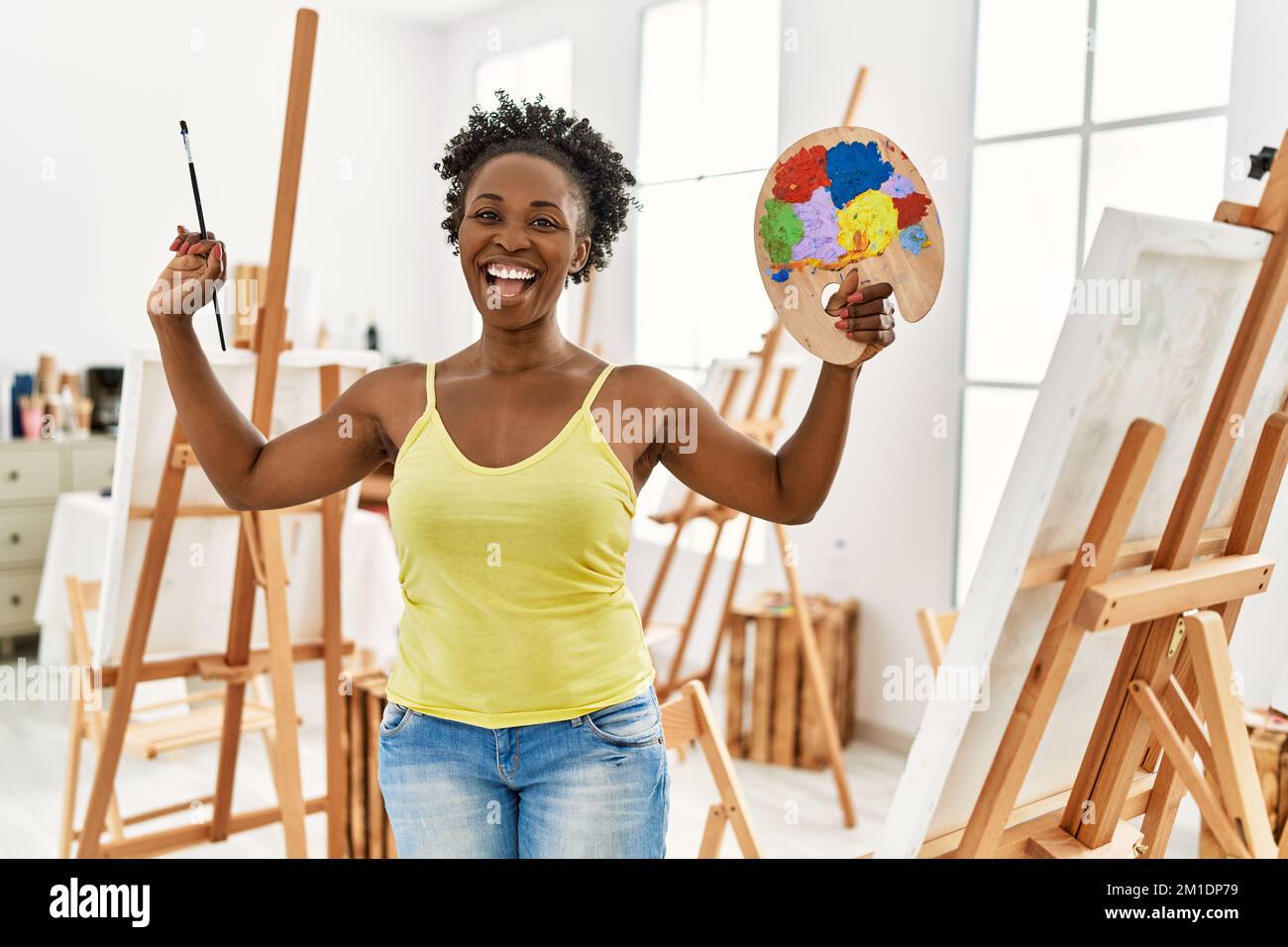 Young african american artist woman smiling happy drawing at art studio ...